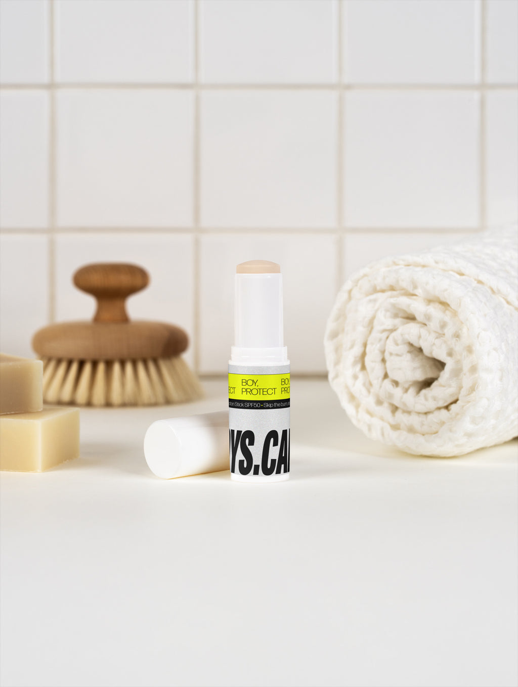 BOY, PROTECT SPF50 sunscreen stick in a bathroom.